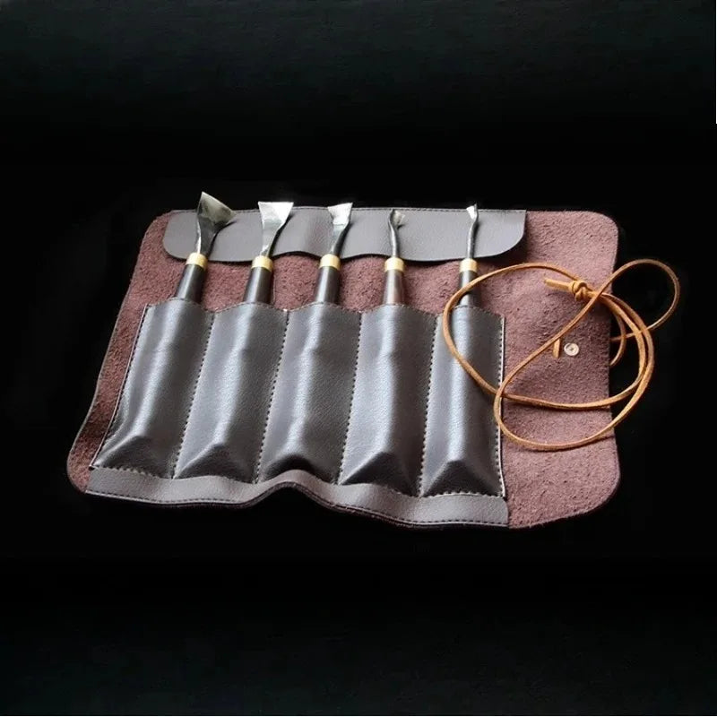 Curved carving chisel tool roll set with multiple blades and wooden handles, leather strap