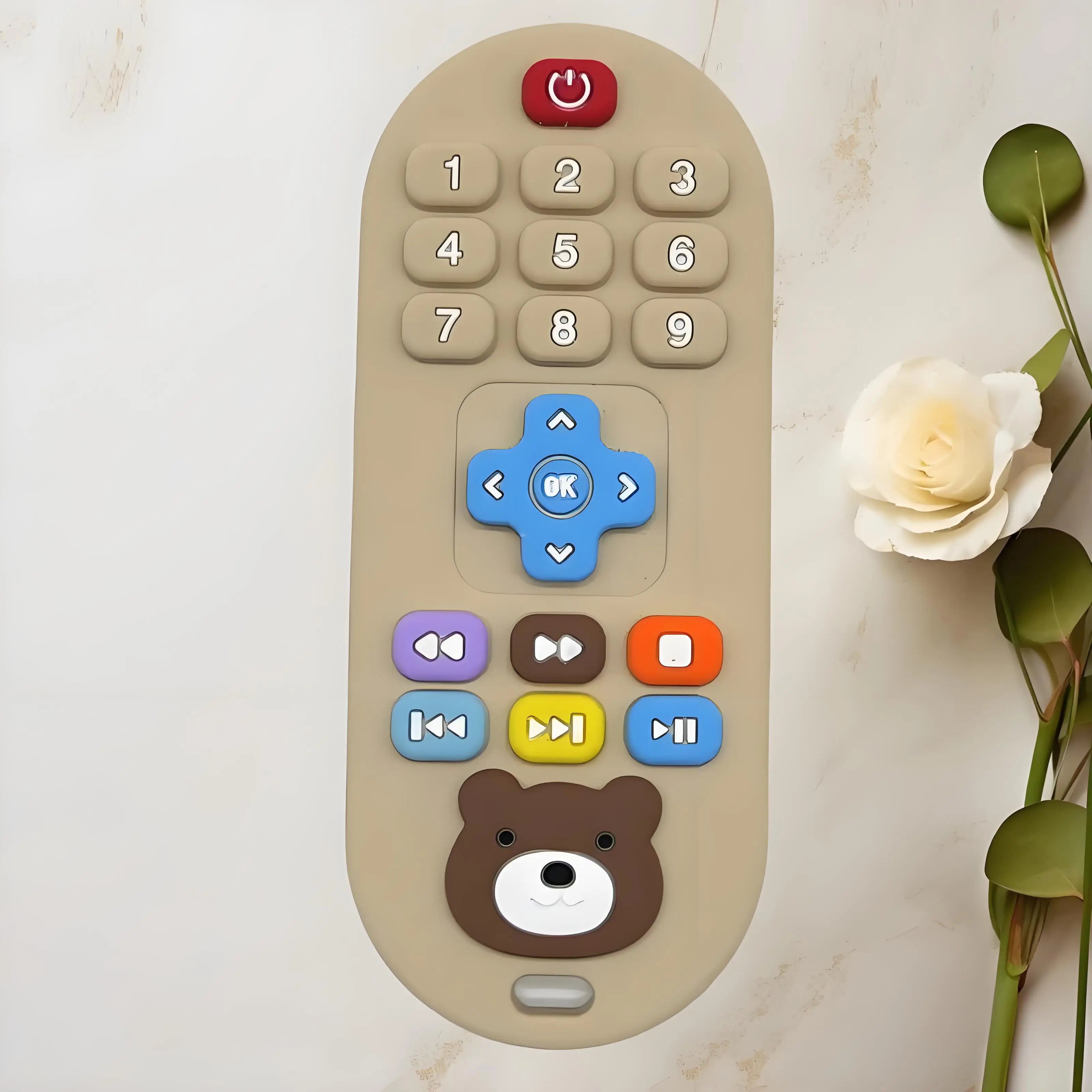 Beige silicone remote control baby teething toy with colorful buttons for infant relief.