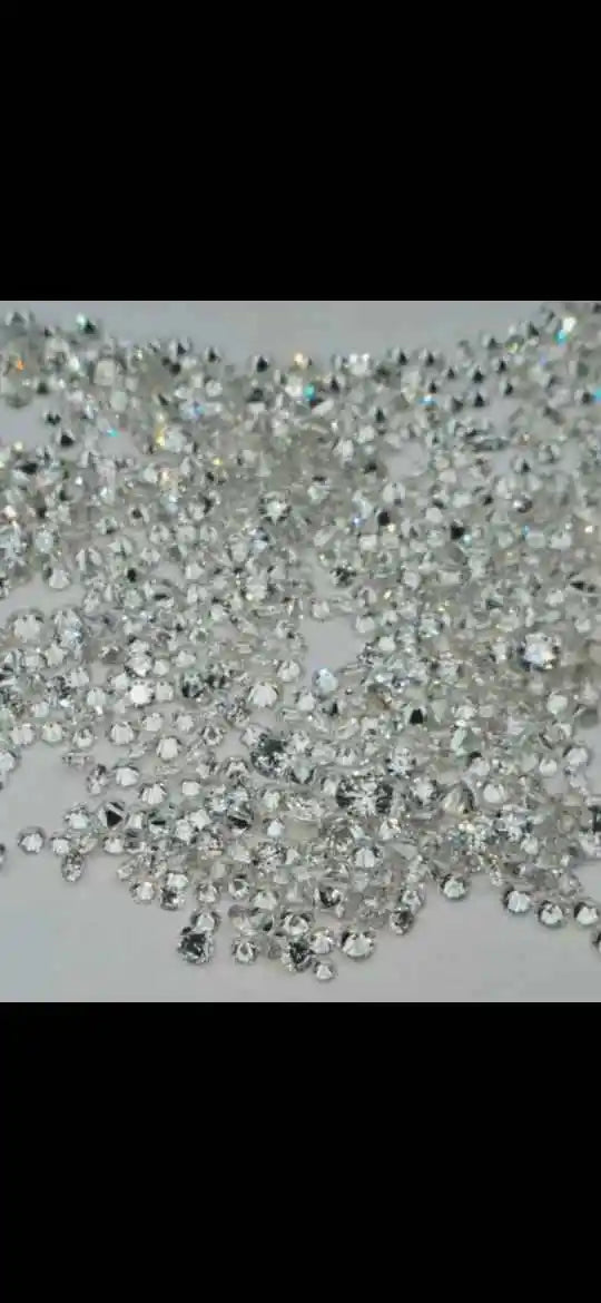 Close-up of loose round brilliant lab-grown diamonds, bright white scattered stones