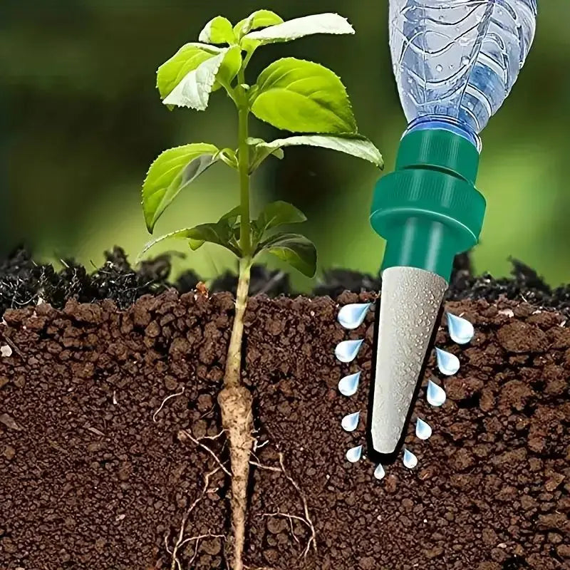 Automatic plant drip irrigation stake in soil with white ceramic outlet and green base