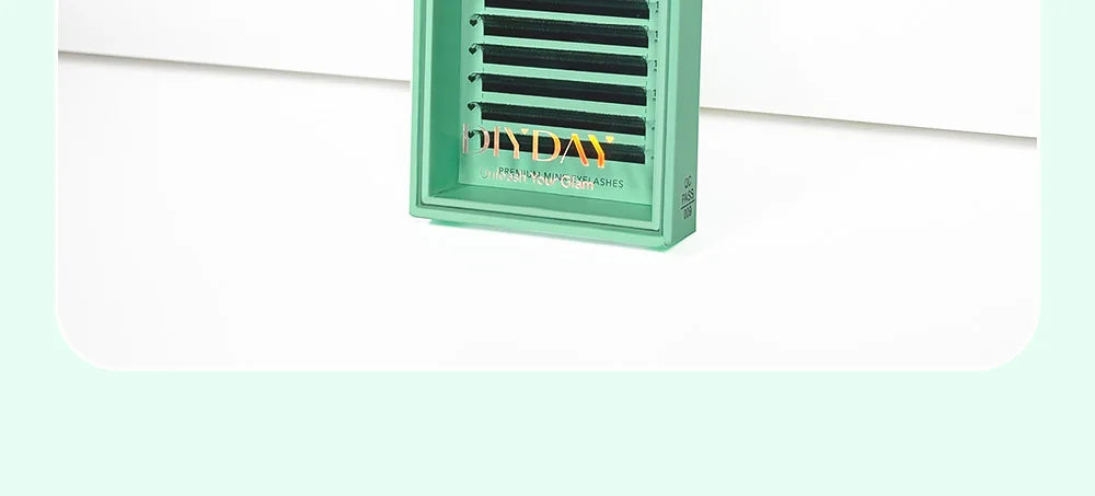 DIYDAY U-shaped faux mink eyelash extension tray with black premade fans in a mint green packaging box.