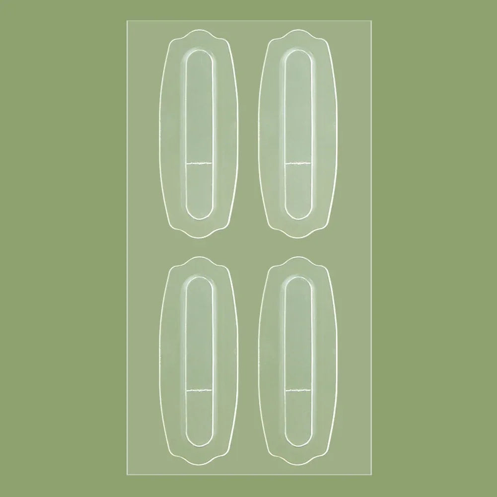 Four clear, oblong, adhesive Tidesmit ear support patches arranged on a transparent backing sheet against a green backdrop.