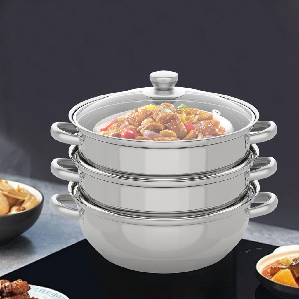 Stainless steel multi-tier steamer pot with lid, filled with cooked meat and vegetables.