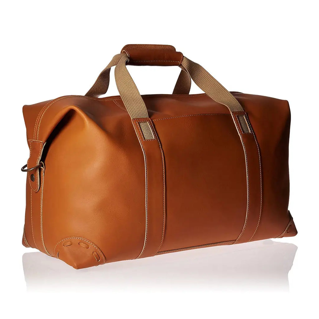 Tan PU leather travel duffel trunk with sturdy woven handles, reinforced base, and spacious capacity for gear.