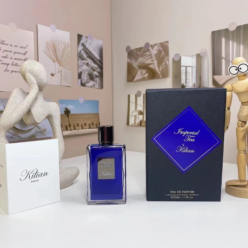Imperial Tea perfume in a 50ml rectangular blue glass bottle with a black cap, displayed next to its navy gift box.