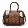 Brown genuine leather mini duffel with floral tooling, cowhide panels, top handles, and shoulder strap. Trunk style.