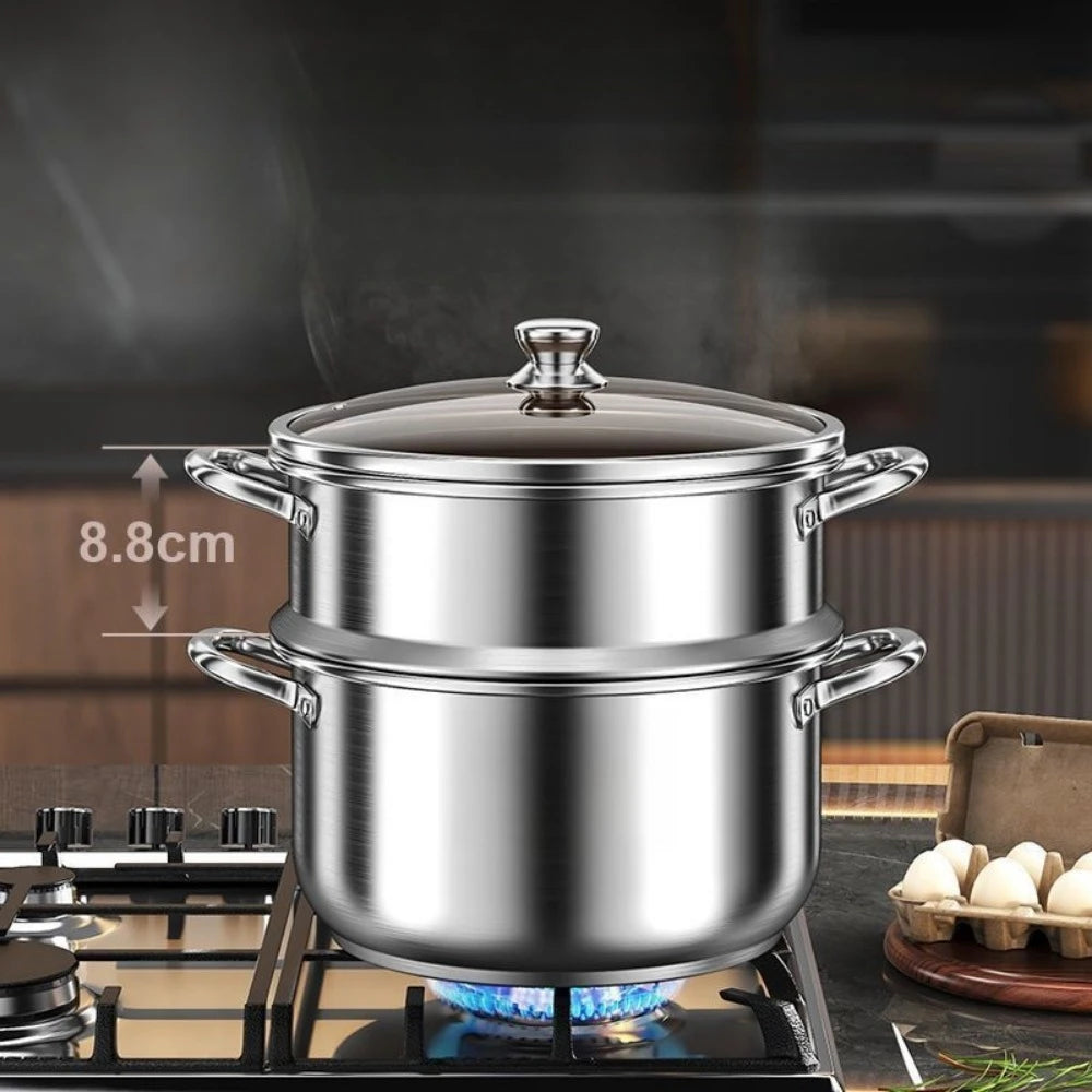 Stainless steel steamer pot with lid and side handles, steaming on a gas stove