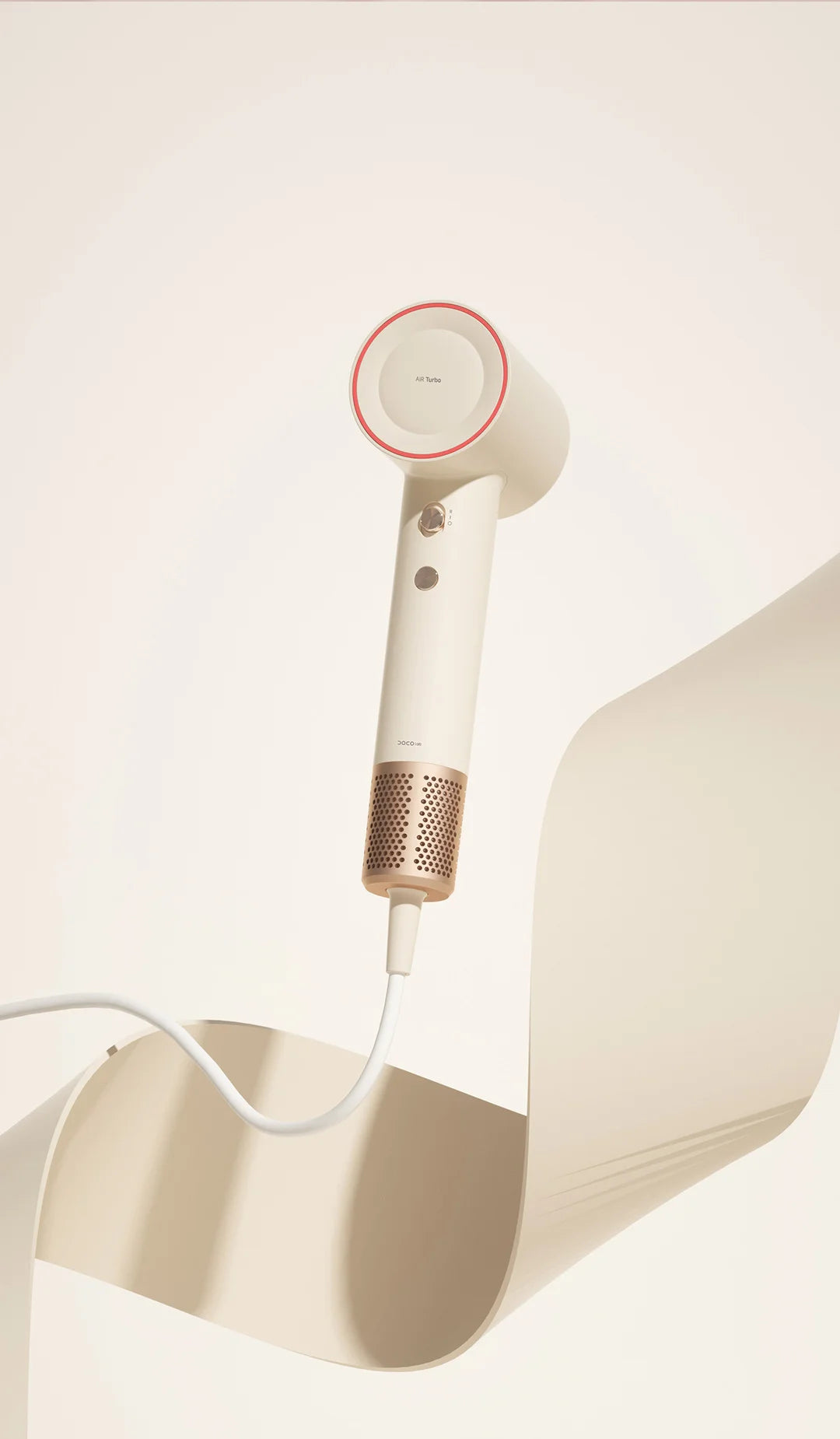 DOCO high-speed hair dryer in beige with rose gold metallic filter, featuring a sleek, professional, compact design.