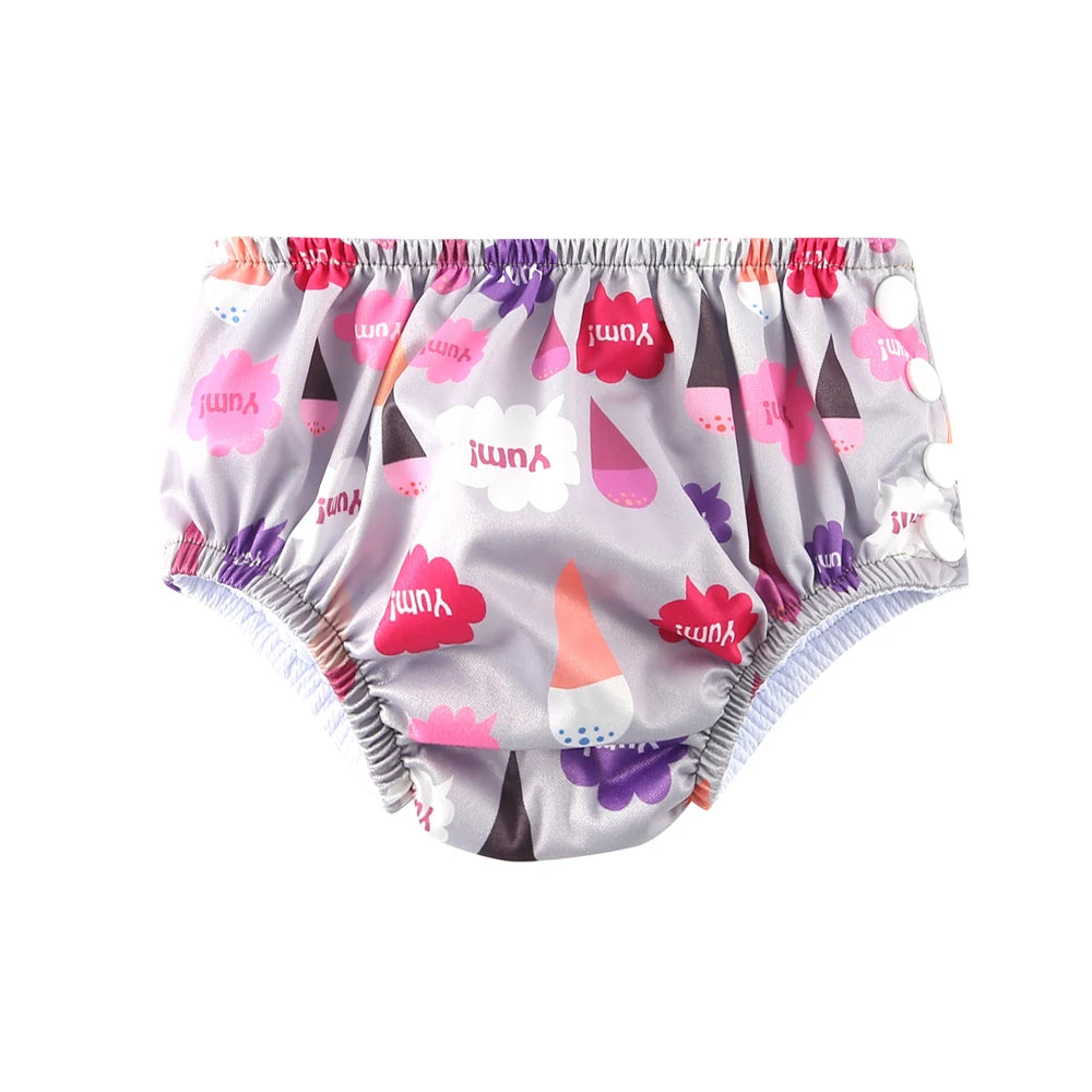 Reusable baby swim diaper in grey with ice cream cone and "Yum" speech bubble print, side snap closure.