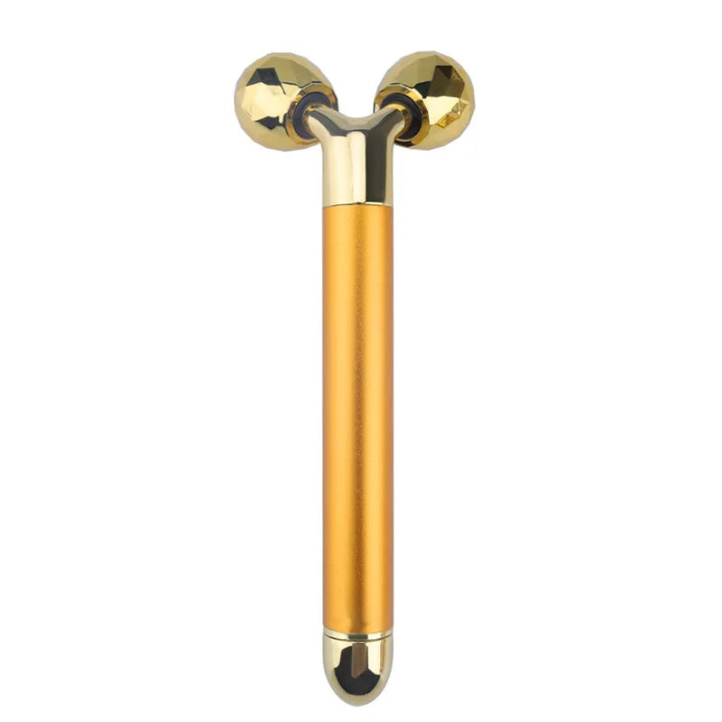 Gold-plated electric 3D face massager with two faceted, diamond-shaped rolling spheres on a Y-shaped handle.