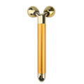 Gold-plated electric 3D face massager with two faceted, diamond-shaped rolling spheres on a Y-shaped handle.