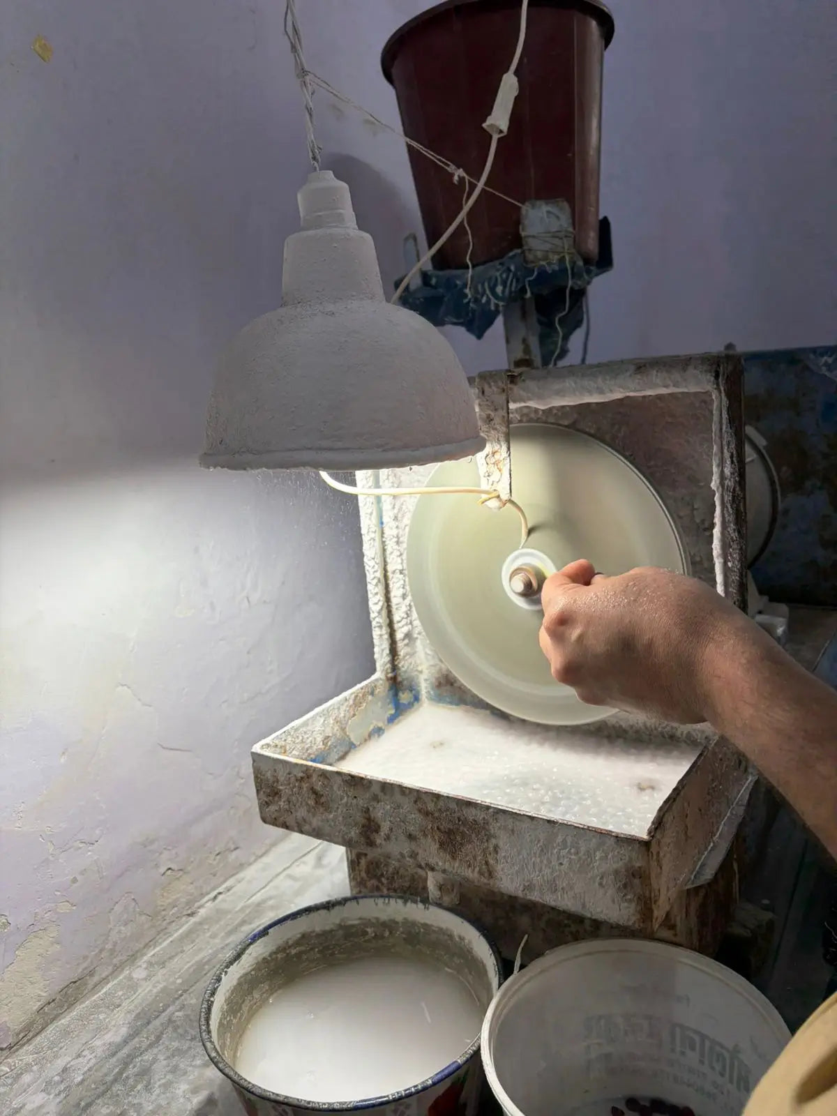 Lapidary grinding station with wheel and concrete basin