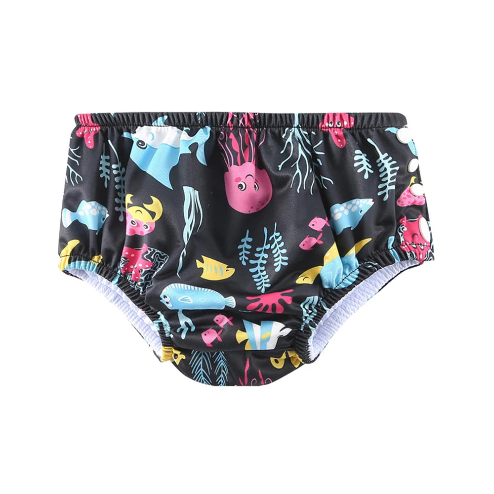 Reusable baby swim diaper in black with colorful sea life and fish print, side snap closure for easy changing.