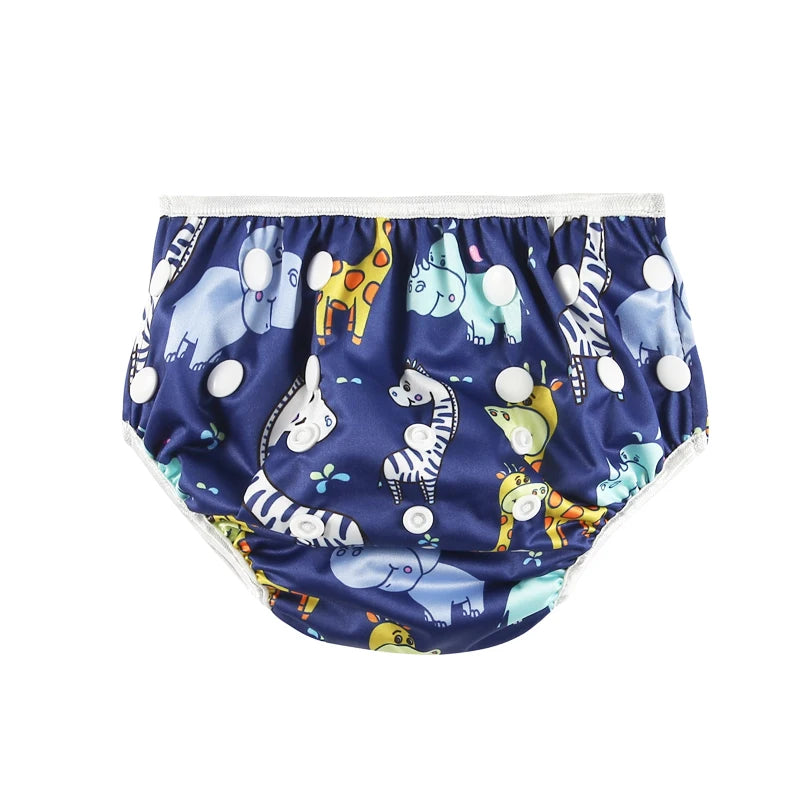 Reusable baby swim diaper in navy blue with colorful safari animal print and adjustable snap closures.
