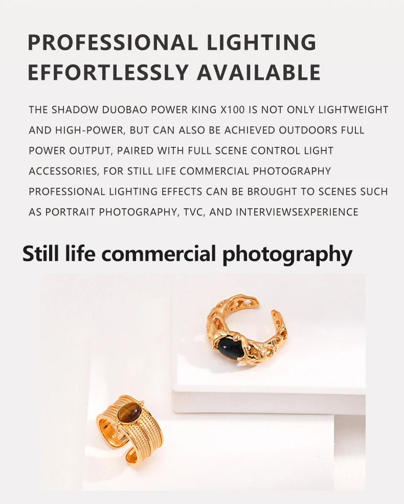 Two gold rings on white pedestals: one with a textured band and brown stone, one with an ornate frame and black stone.