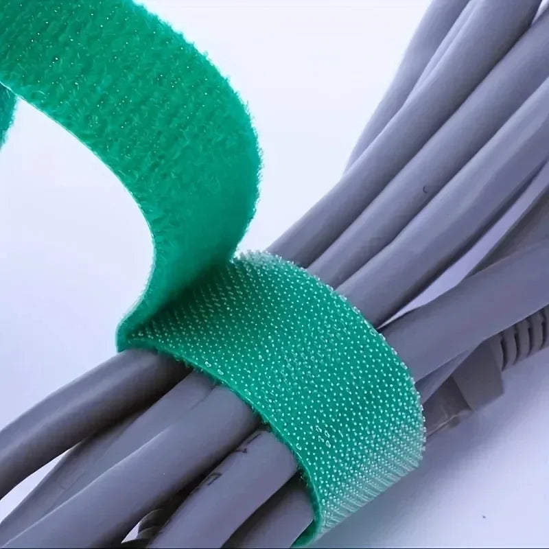 Green hook-and-loop tie band securing stacked stems close-up.