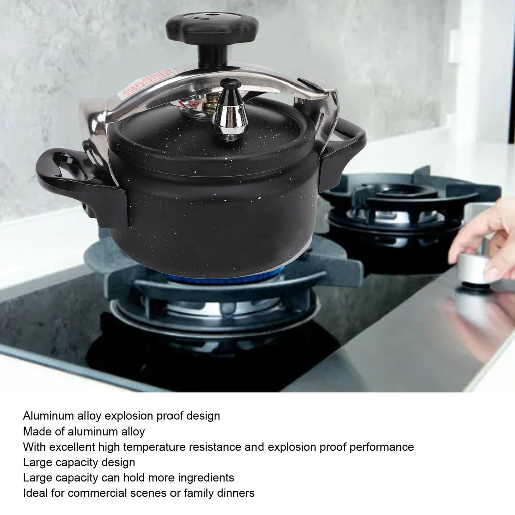 Black pressure canner with domed lid, black vent knob, aluminum rim, and side handles