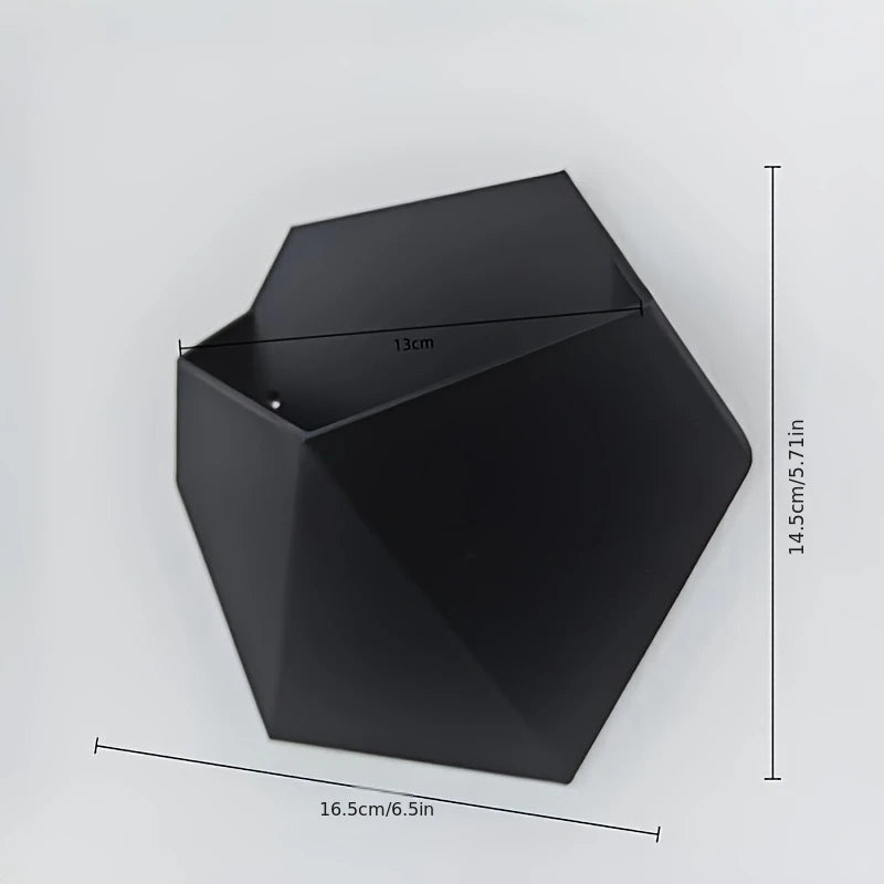 Black hexagonal wall planter, 16.5cm wide and 14.5cm tall, open top with mounting holes.