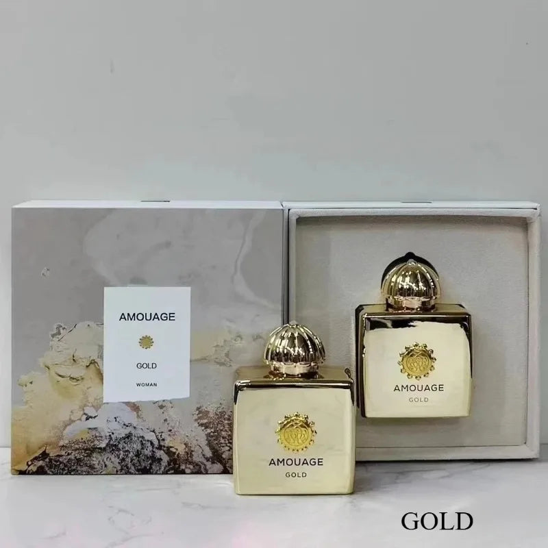 Amouage Gold Woman fragrance set featuring two luxurious, metallic gold square perfume bottles with ornate gold caps.