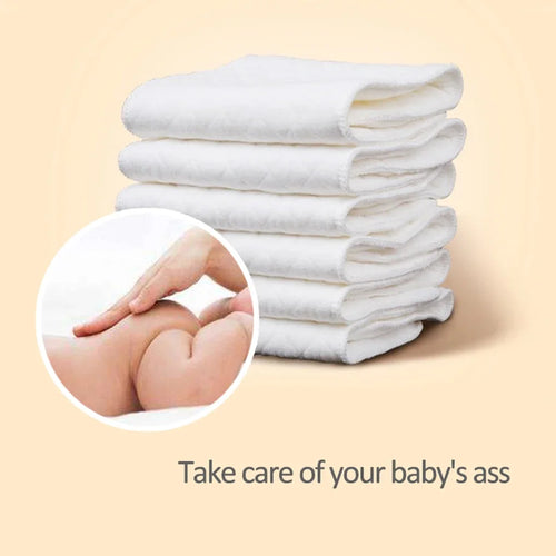 Stack of soft white baby diaper inserts for gentle baby care and skin hygiene.