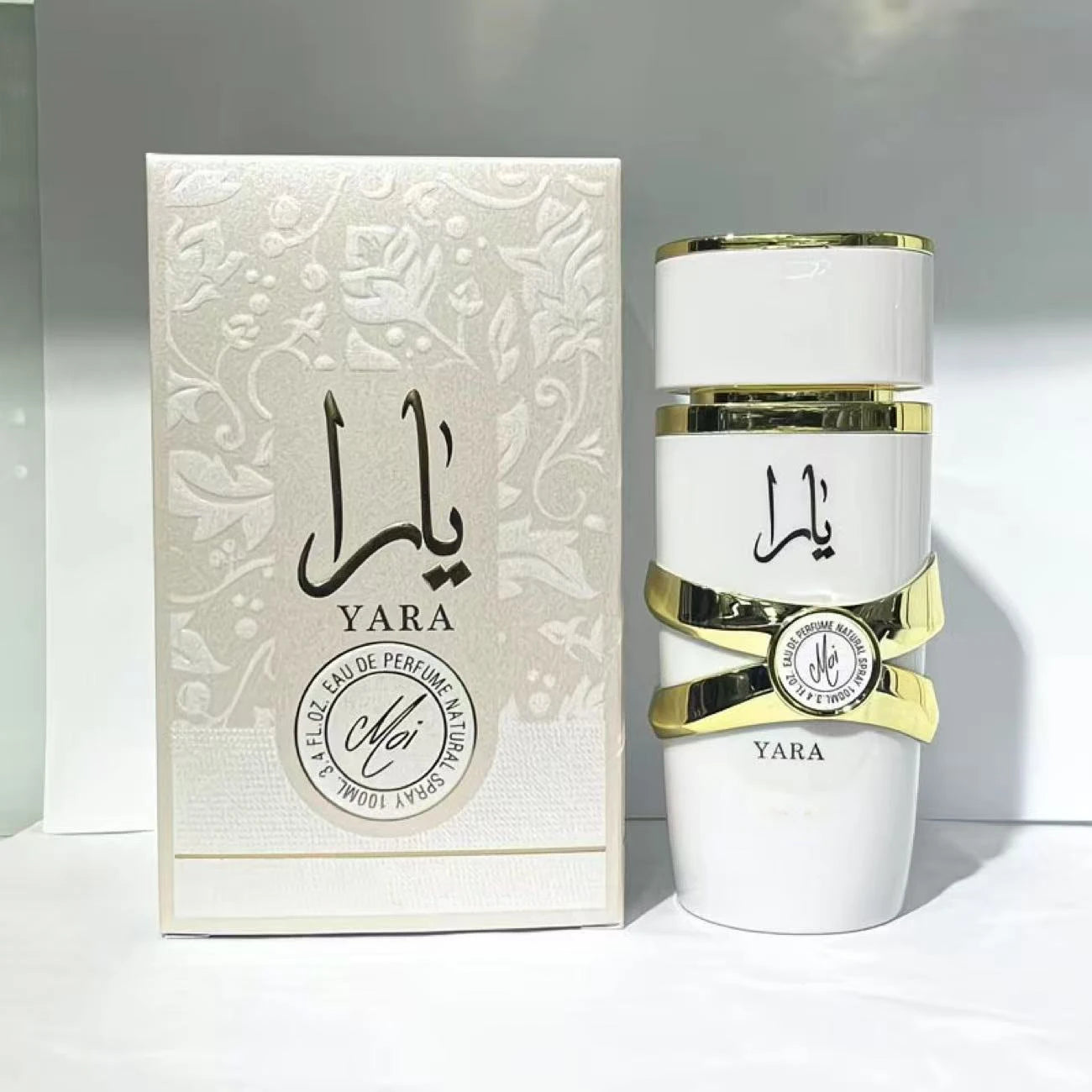 Yara Moi Eau de Parfum 100ml. Elegant white bottle with gold accents. Long-lasting woody aromatic fragrance for women.