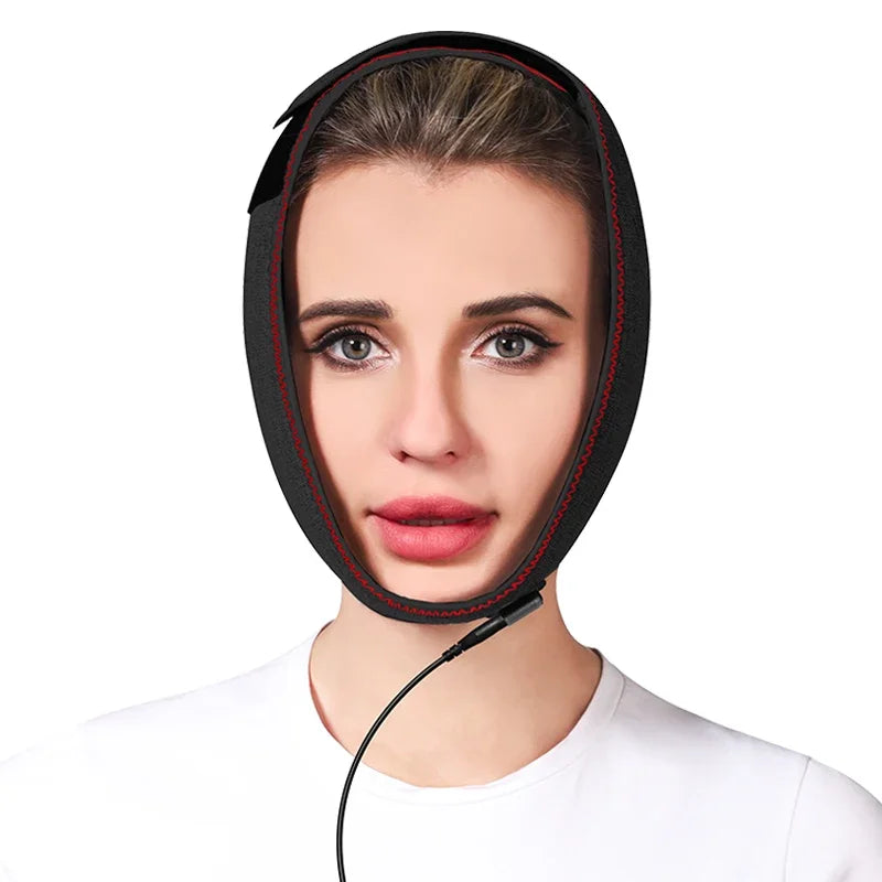 Woman wearing a black neoprene wrap-around jaw heating pad with red trim and a power cord.