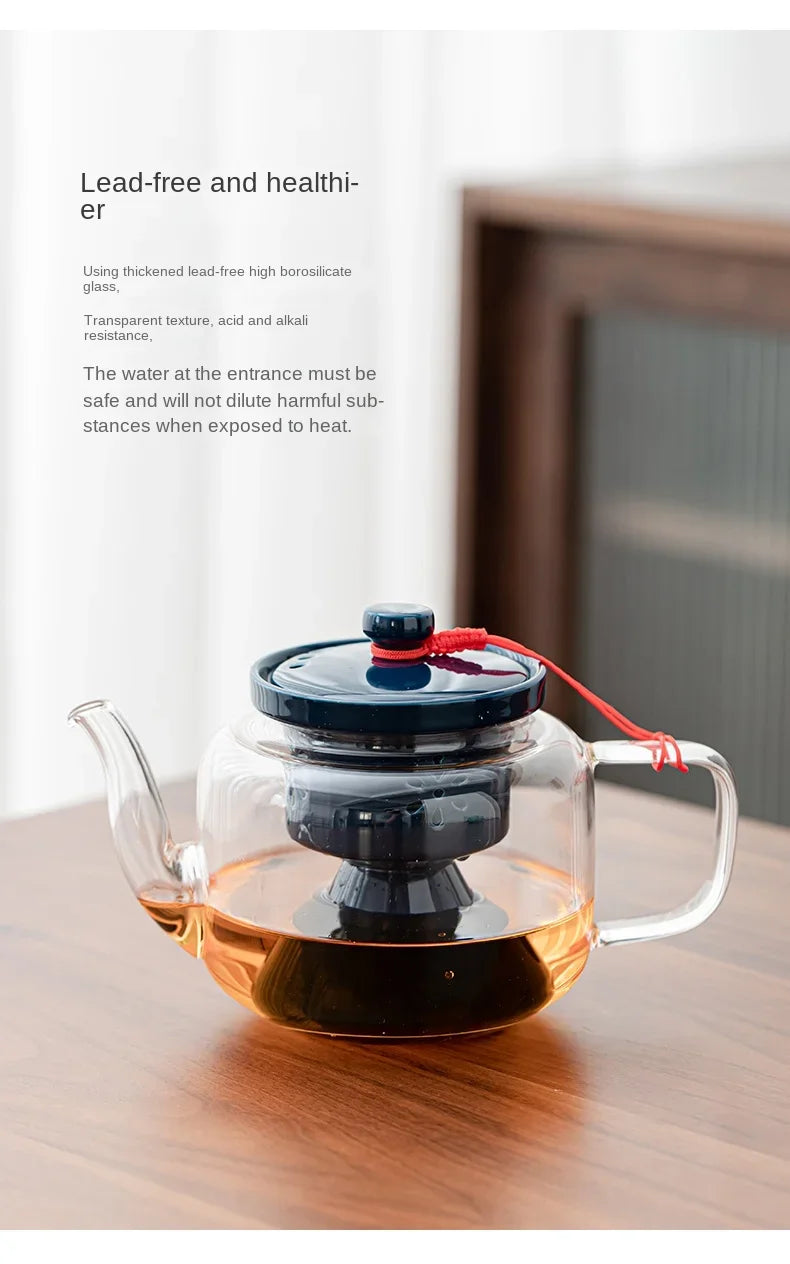 Borosilicate glass teapot with dark blue ceramic lid, built-in infuser, and red decorative cord.