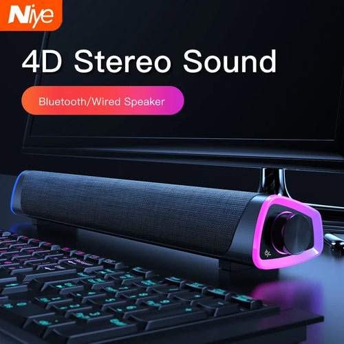 Computer speaker bar with dark fabric grille and RGB-lit front control dial