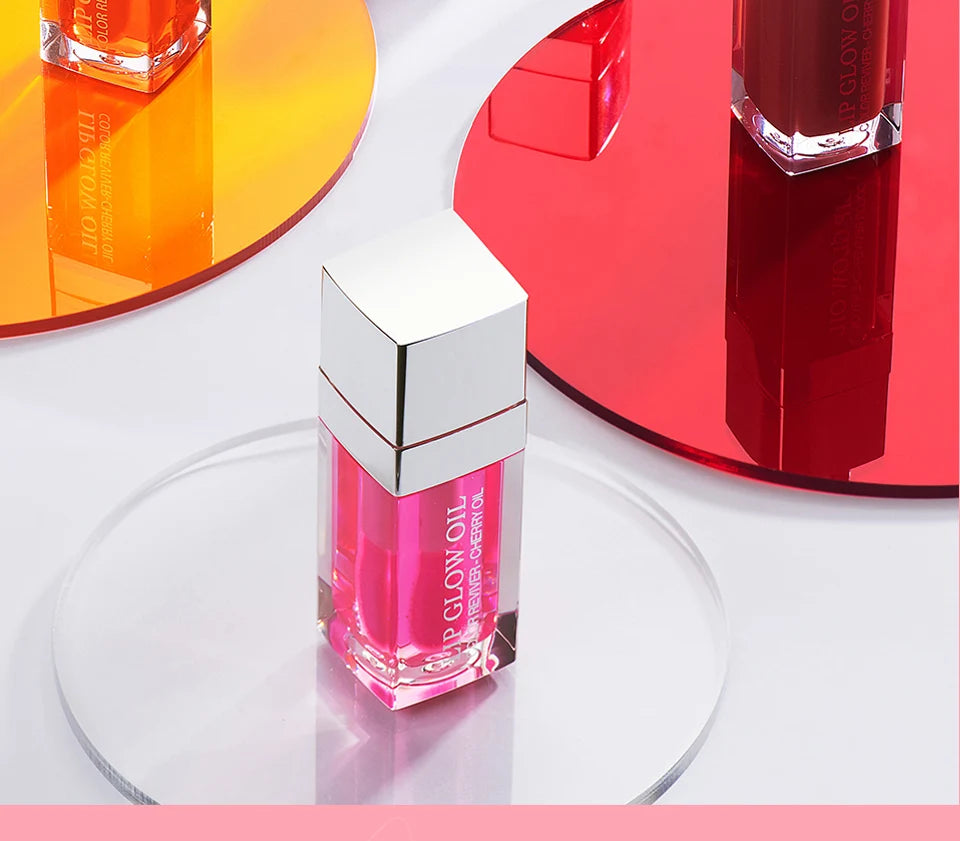 Pink crystal jelly lip oil with a shiny finish on display, perfect for moisturizing and plumping lip makeup looks.