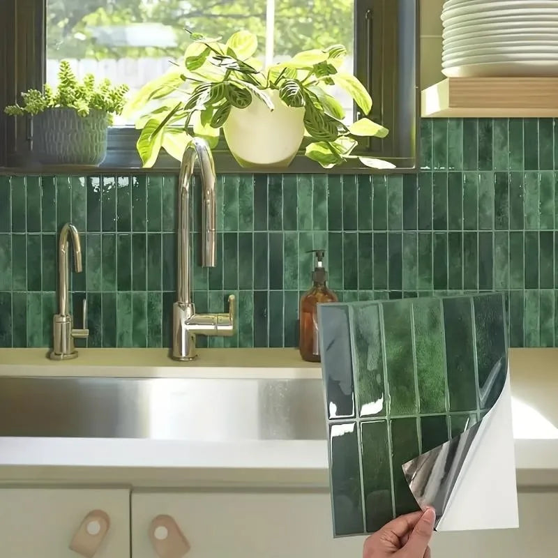 Dark green peel-and-stick backsplash tile sheet with glossy subway tile pattern, being applied to wall