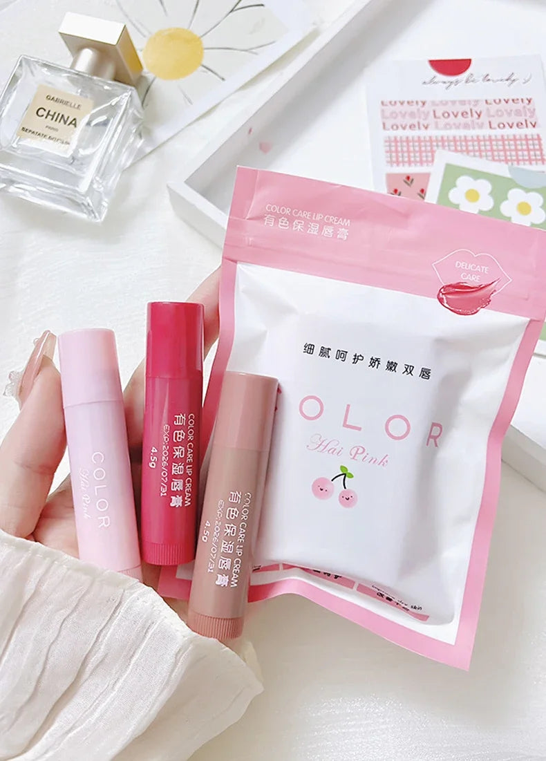 Three moisturizing lip balm tubes in pink, red, and nude, designed to tint and hydrate lips for a smooth finish.