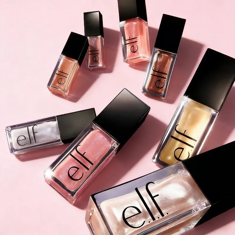 e.l.f. Glow Reviver Lip Oil collection in multiple glossy, moisturizing shades arranged on a soft pink background.