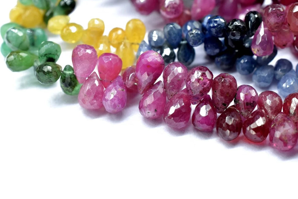 Close-up of multi-color faceted drop beads (pink, blue, green, yellow), 4x6mm