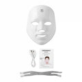 White LED facial mask, USB charging cable, instruction manual, and gray elastic head strap on a white background.