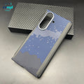 Blue and black checkered Samsung Galaxy Z Fold case with a silver camera cutout, resting on a carbon fiber box.
