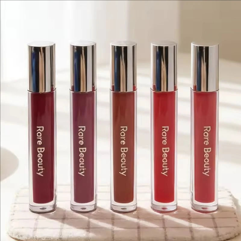 Five Rare Beauty Soft Pinch Tinted Lip Oil tubes in various shades, showing a glossy, moisturizing lip stain formula.
