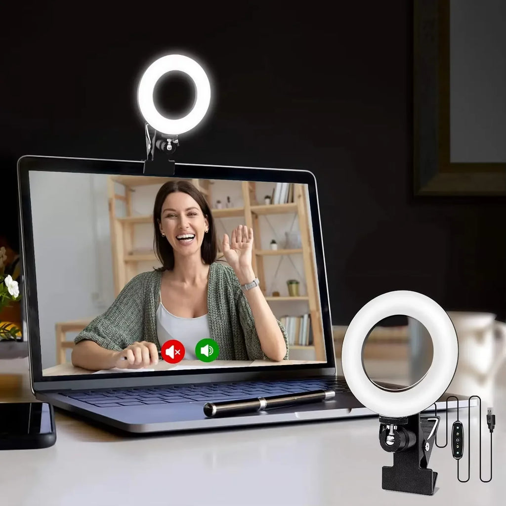 Small black LED ring light with a clip-on base for laptop webcams, used for video conferencing lighting.