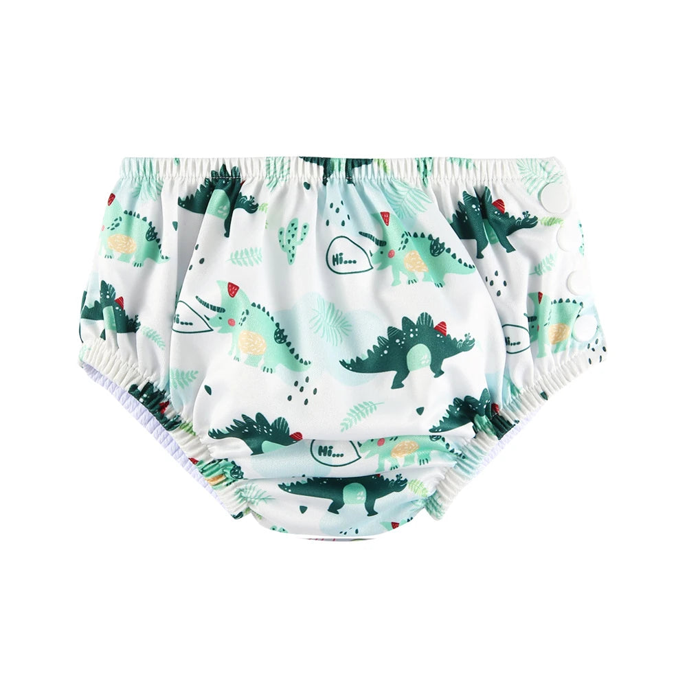 Reusable cloth swim diaper with cute green dinosaur print and side snap closures for babies.