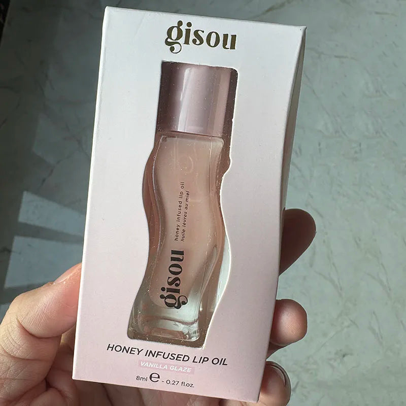 Gisou Honey Infused Lip Oil in Vanilla Glaze, a moisturizing, glossy, and plumping lip treatment in pink packaging.
