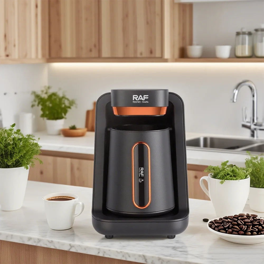 RAF black and copper electric Turkish coffee maker on a marble kitchen counter with coffee beans and a cup.