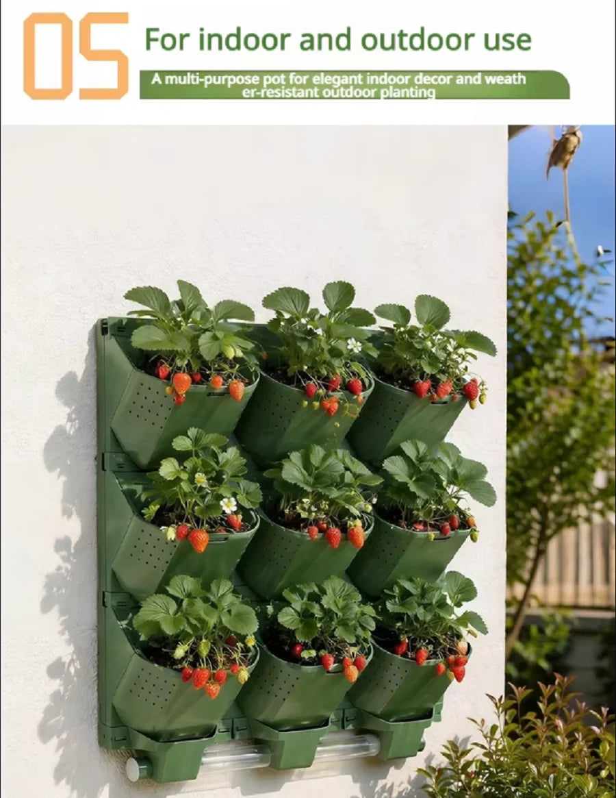 Green modular vertical garden planter with multiple planting cups and strawberries