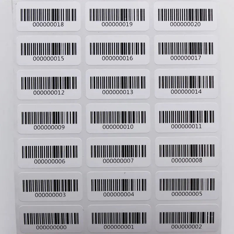 Close view of barcode label grid with black bars and digits on white rounded stickers.