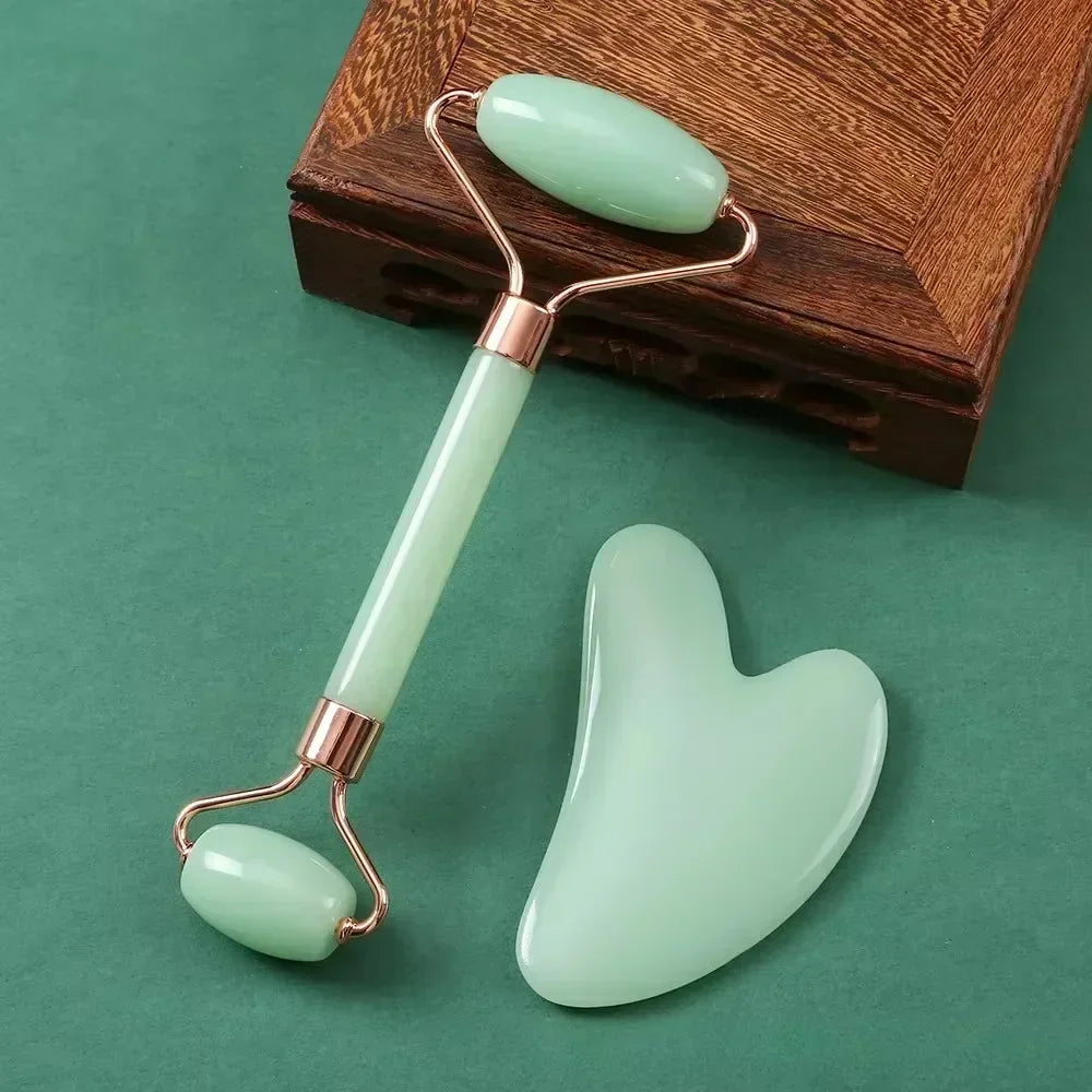 Light green jade face roller and heart-shaped gua sha scraper set for facial massage, skin lifting, and anti-aging.
