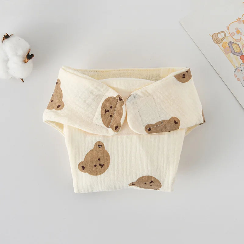 Reusable muslin baby diaper cover featuring cute bear print on cream fabric, soft cloth baby care essential.