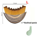 Crescent-shaped facial massage brush with brown bristles and wood-grain handle, plus a small green blackhead spatula.