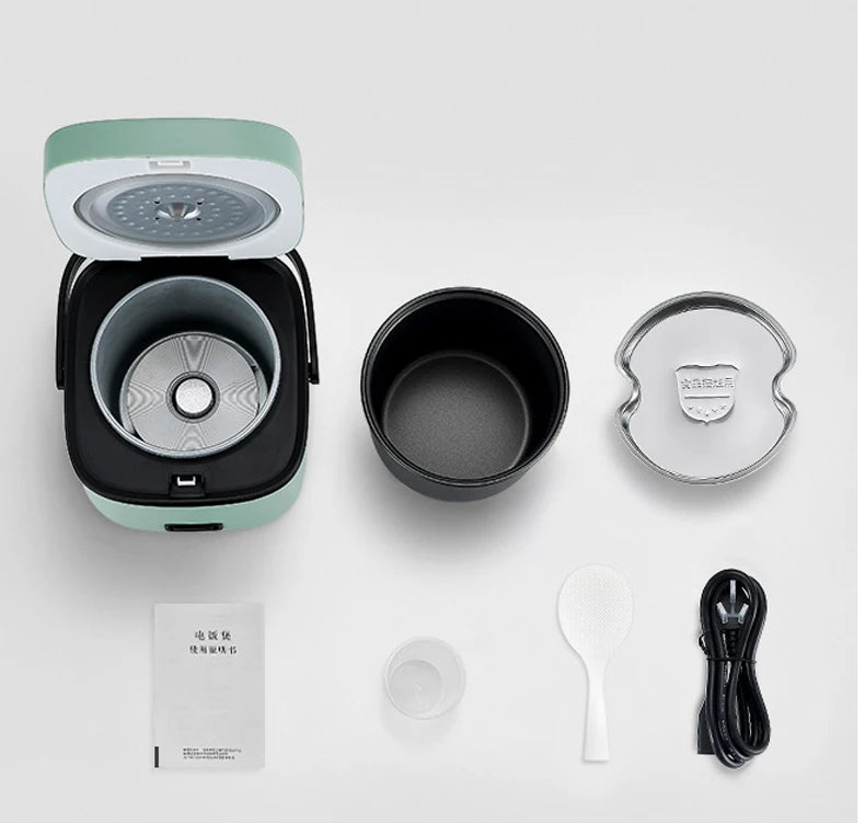 Mini electric rice cooker open with removable inner pot and accessories, teal base.