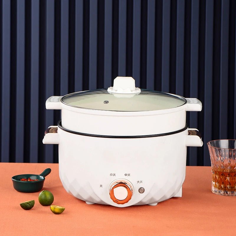 White electric hot pot multi-cooker with glass lid and front orange power control knob