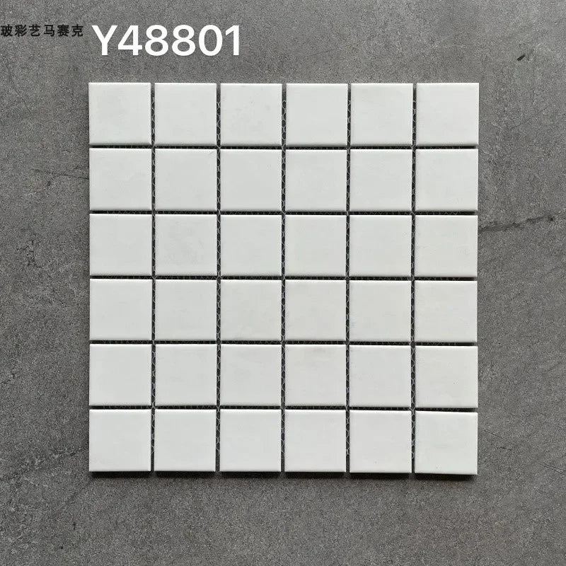 White ceramic mosaic tile sheet with glossy square grid and dark grout lines