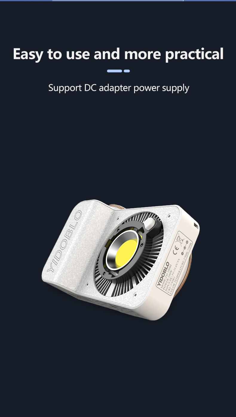 Compact white LED video light with a central circular cooling fan and yellow diode for portable studio lighting.