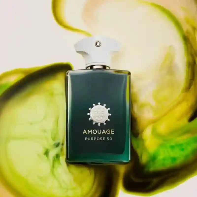 Amouage Purpose 50 perfume bottle in a rectangular deep green glass bottle with a white cap, set against green ink.